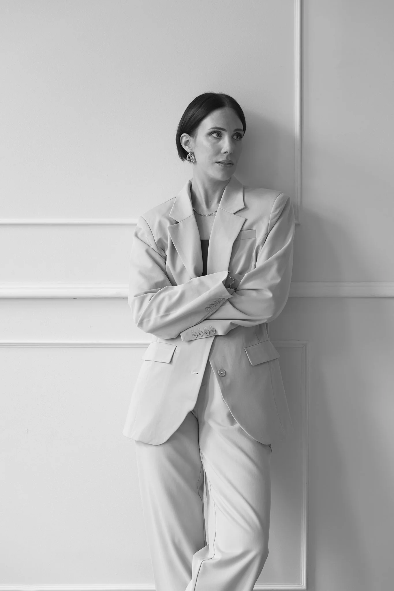 Black and white photo of Nat with folded arms
