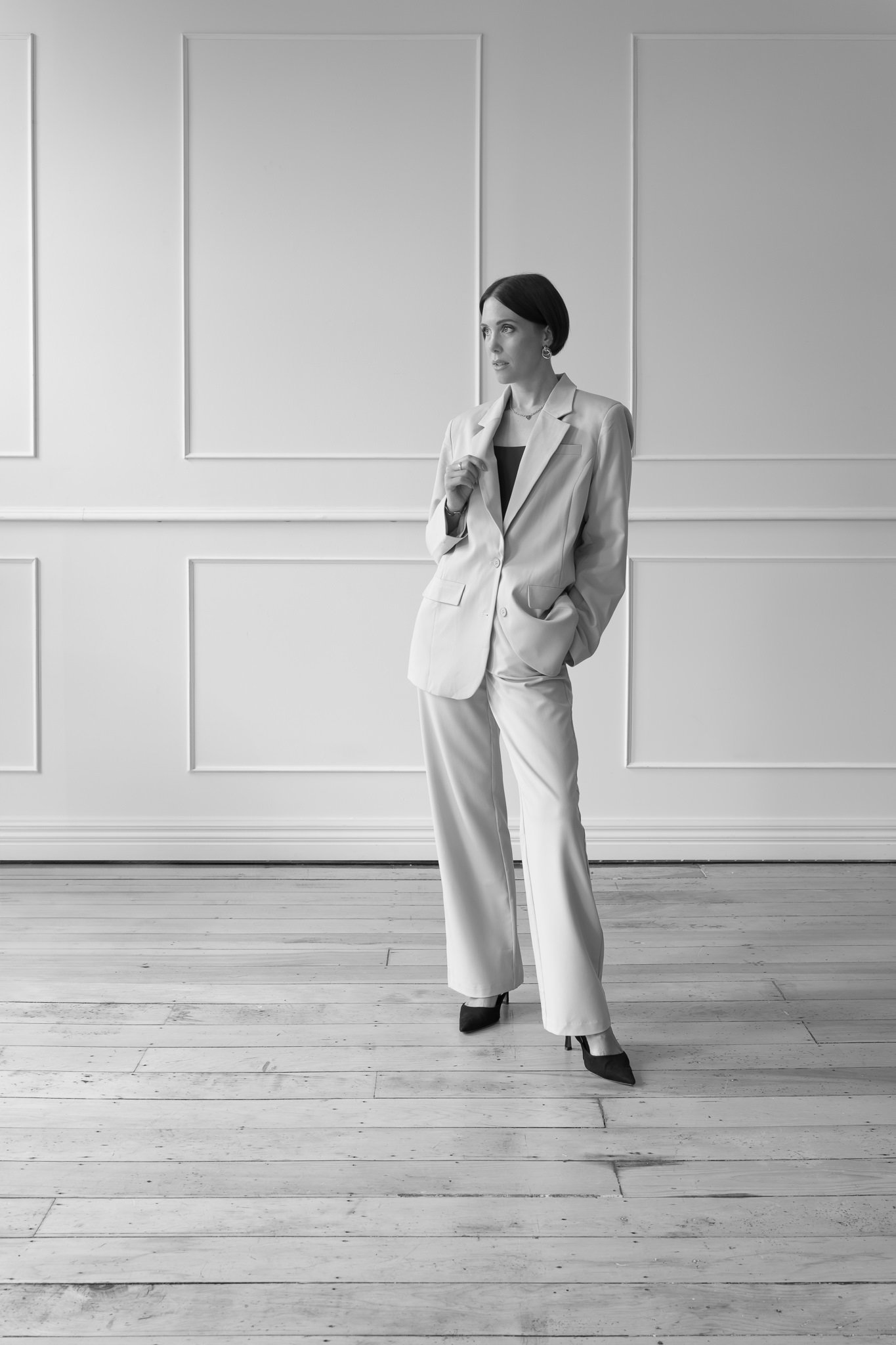 Black and white photo of Nat with a hand in her pocket
