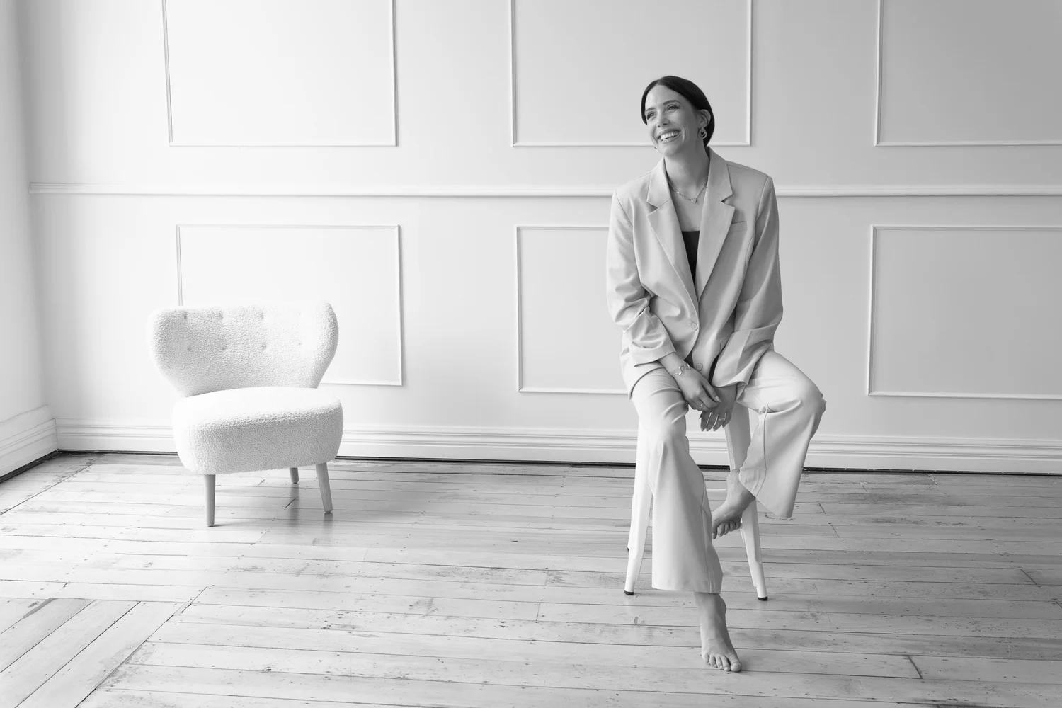 Black and white photo of Nat perched on a stool