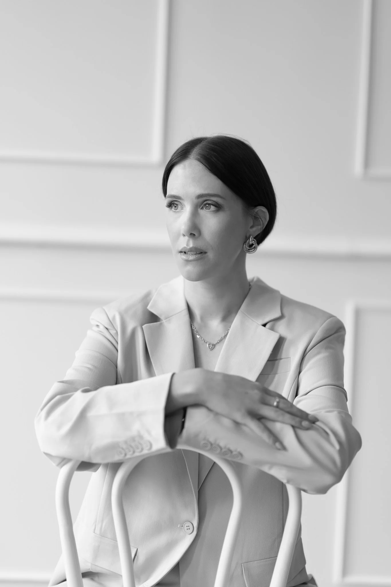 Black and white photo of Nat leaning on a chair