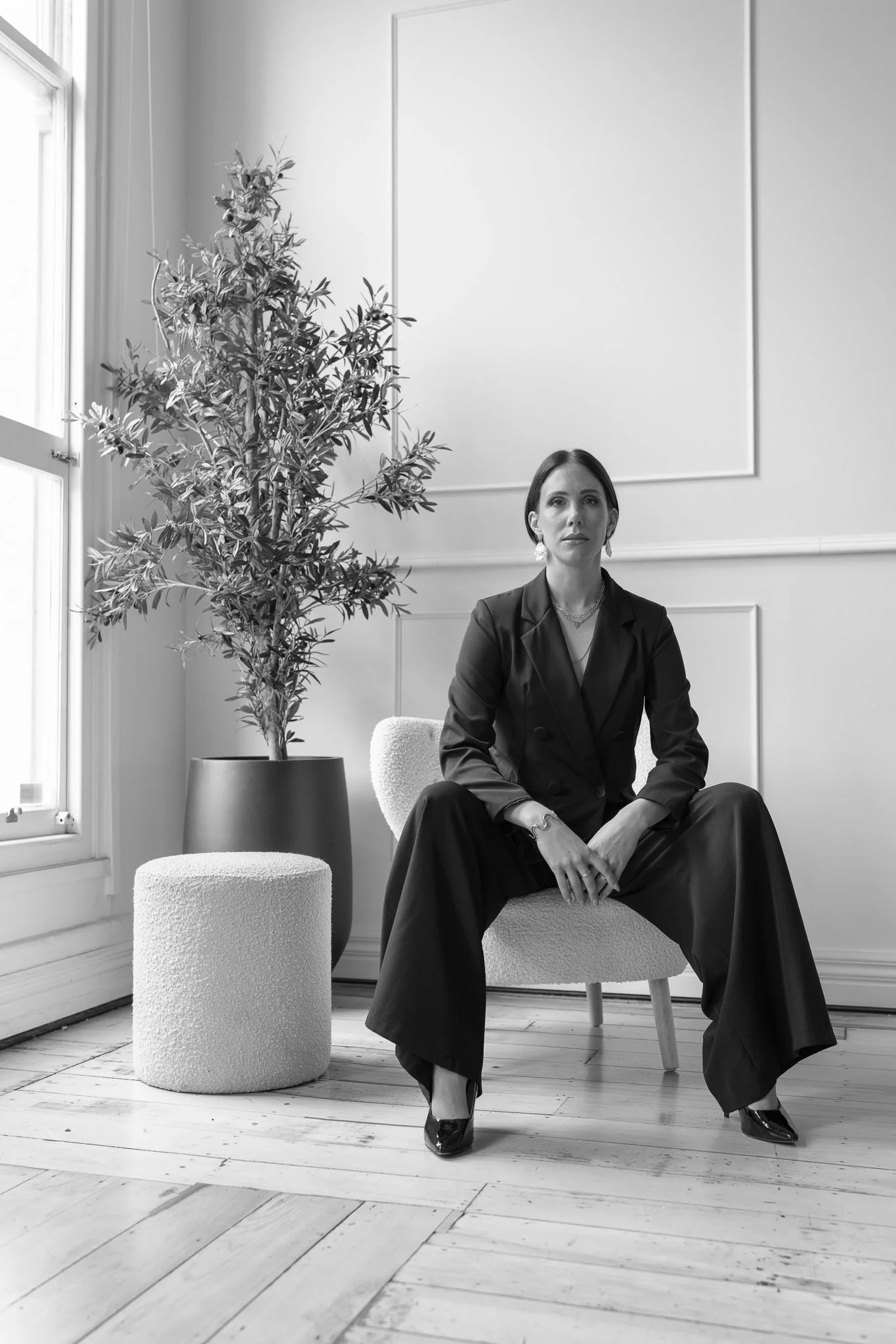Black and white photo of Nat in a wide-leg black suit