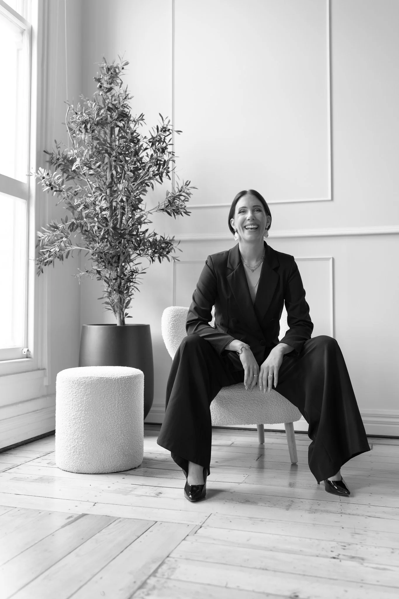 Black and white photo of Nat smiling in a black suit