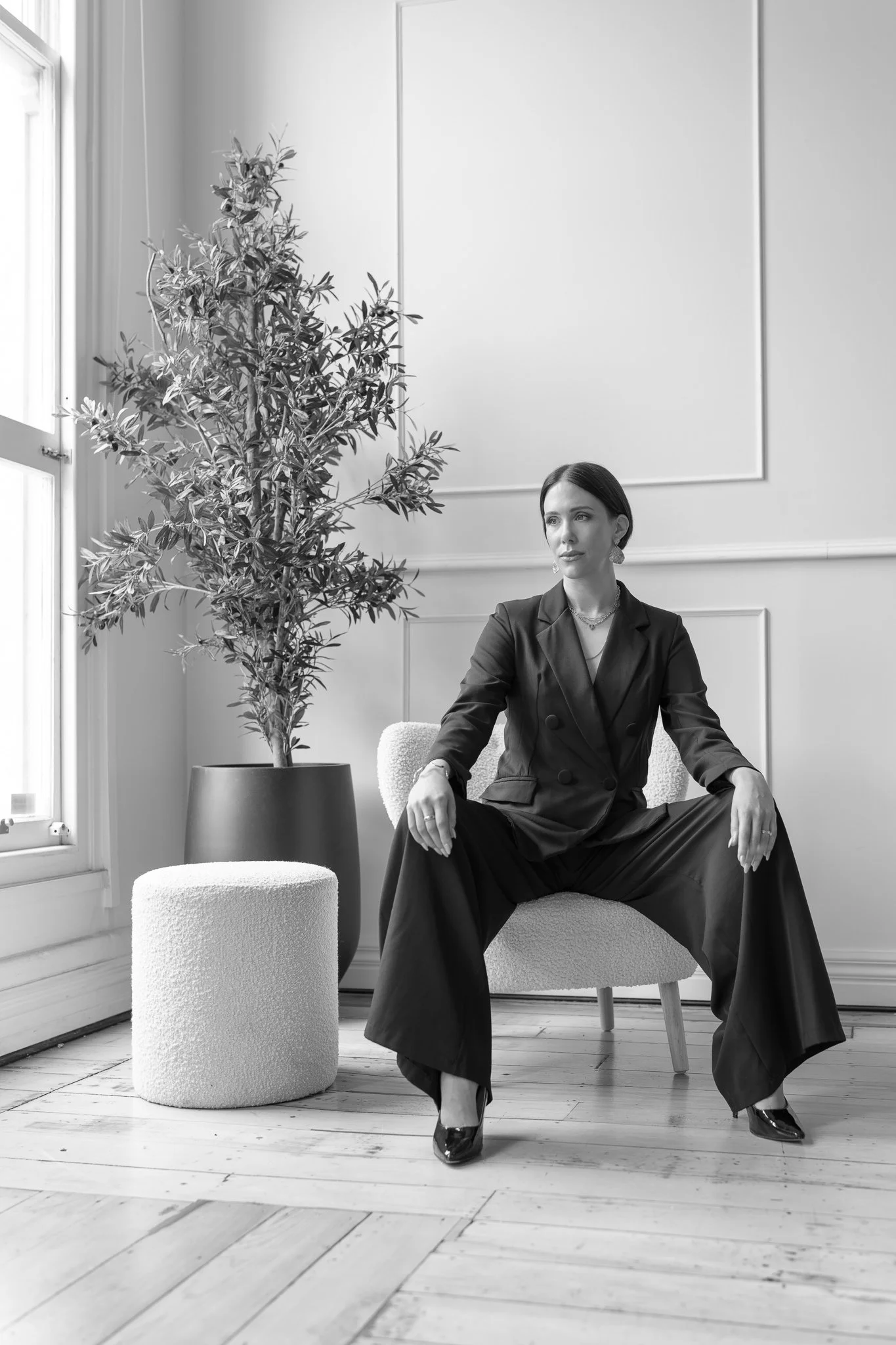 Black and white photo of Nat seated with hands on her knees