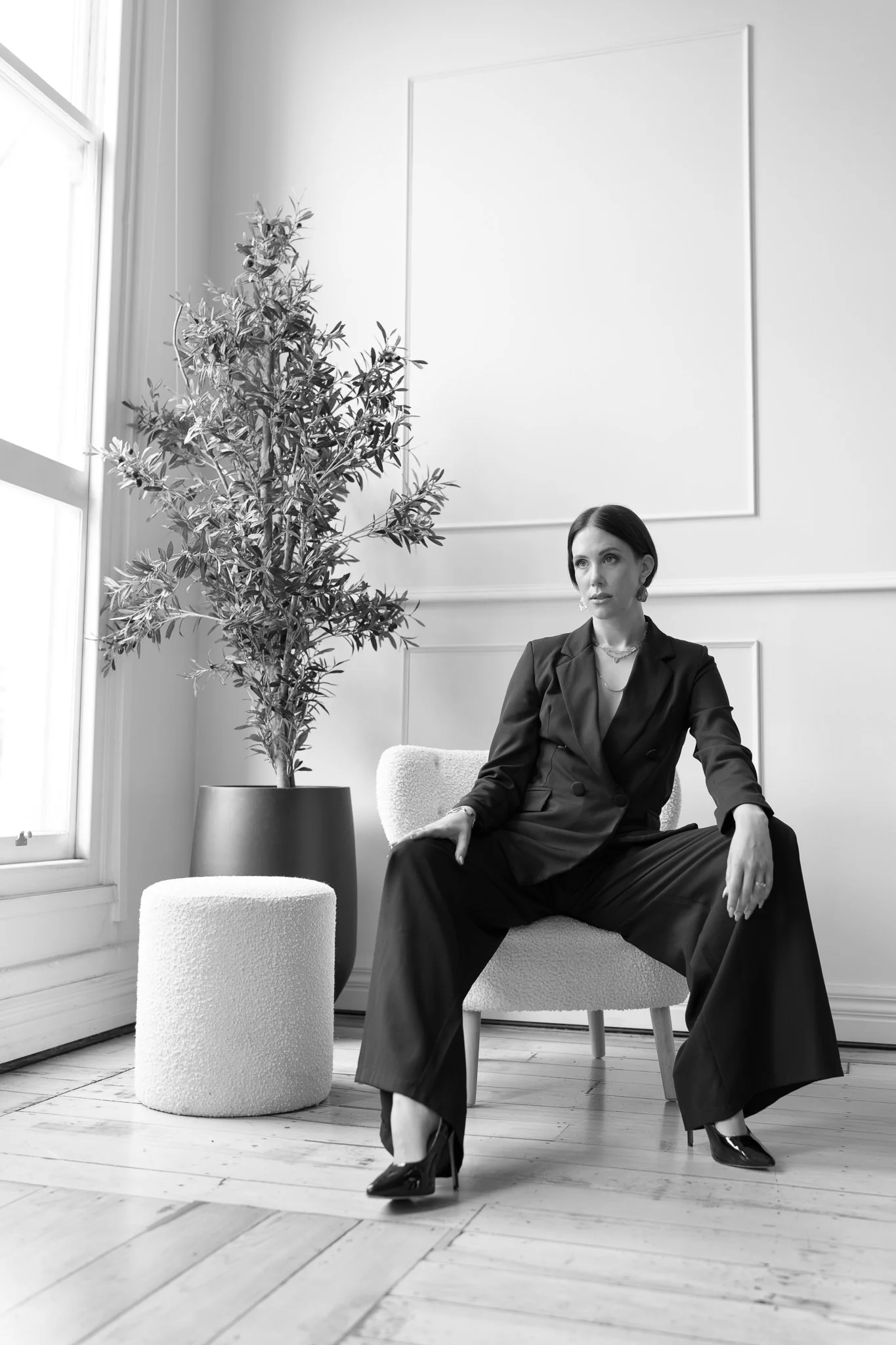 Black and white photo of Nat seated sideways