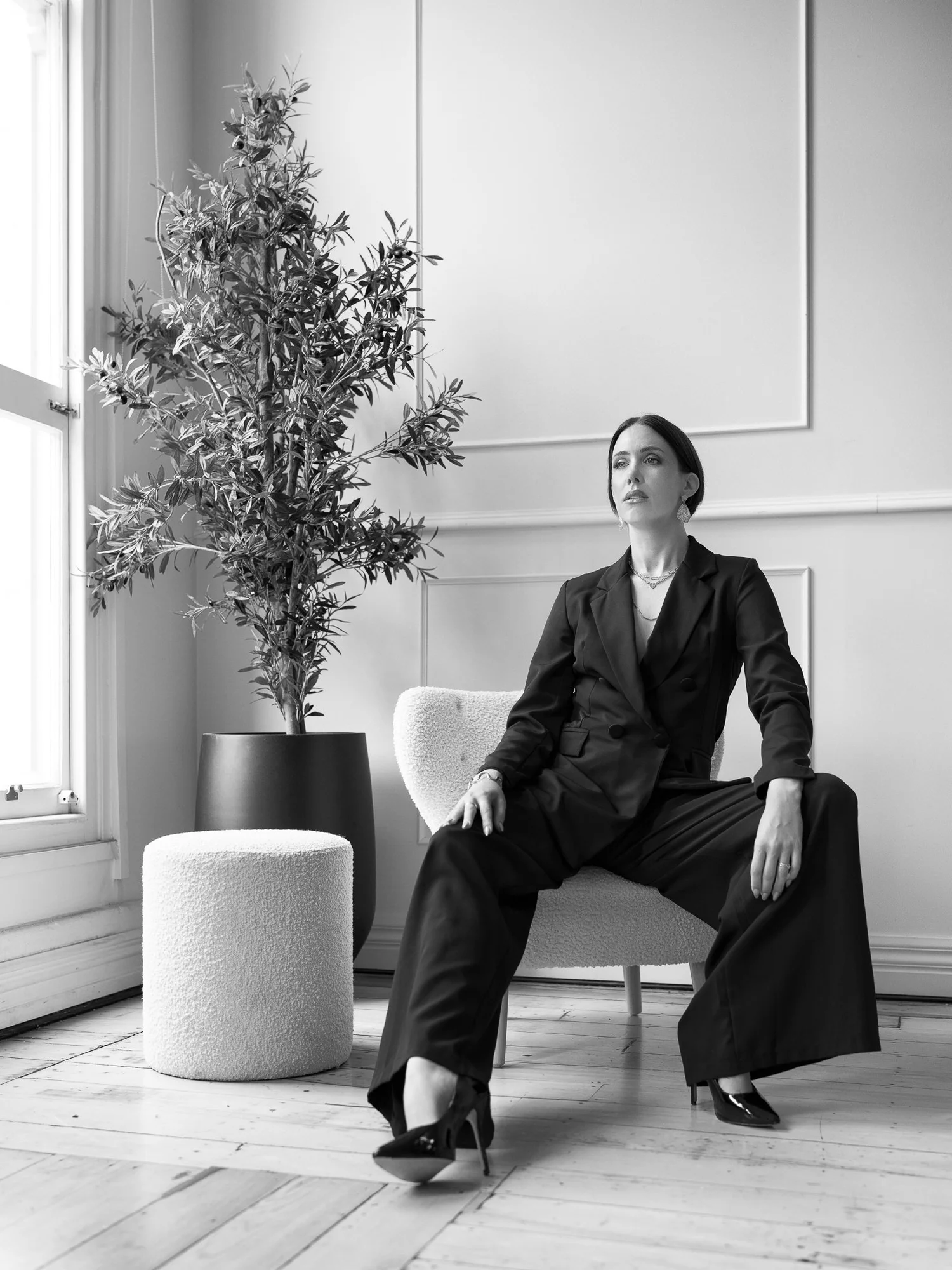 Black and white photo of Nat leaning back in her chair