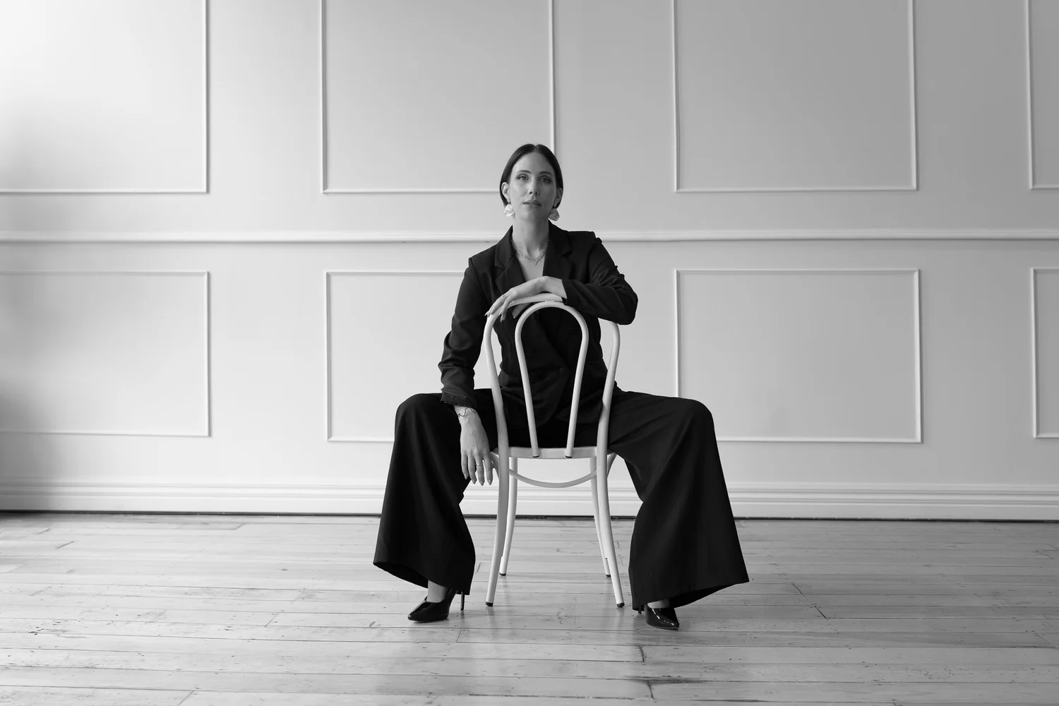 Black and white photo of Nat on a bentwood chair