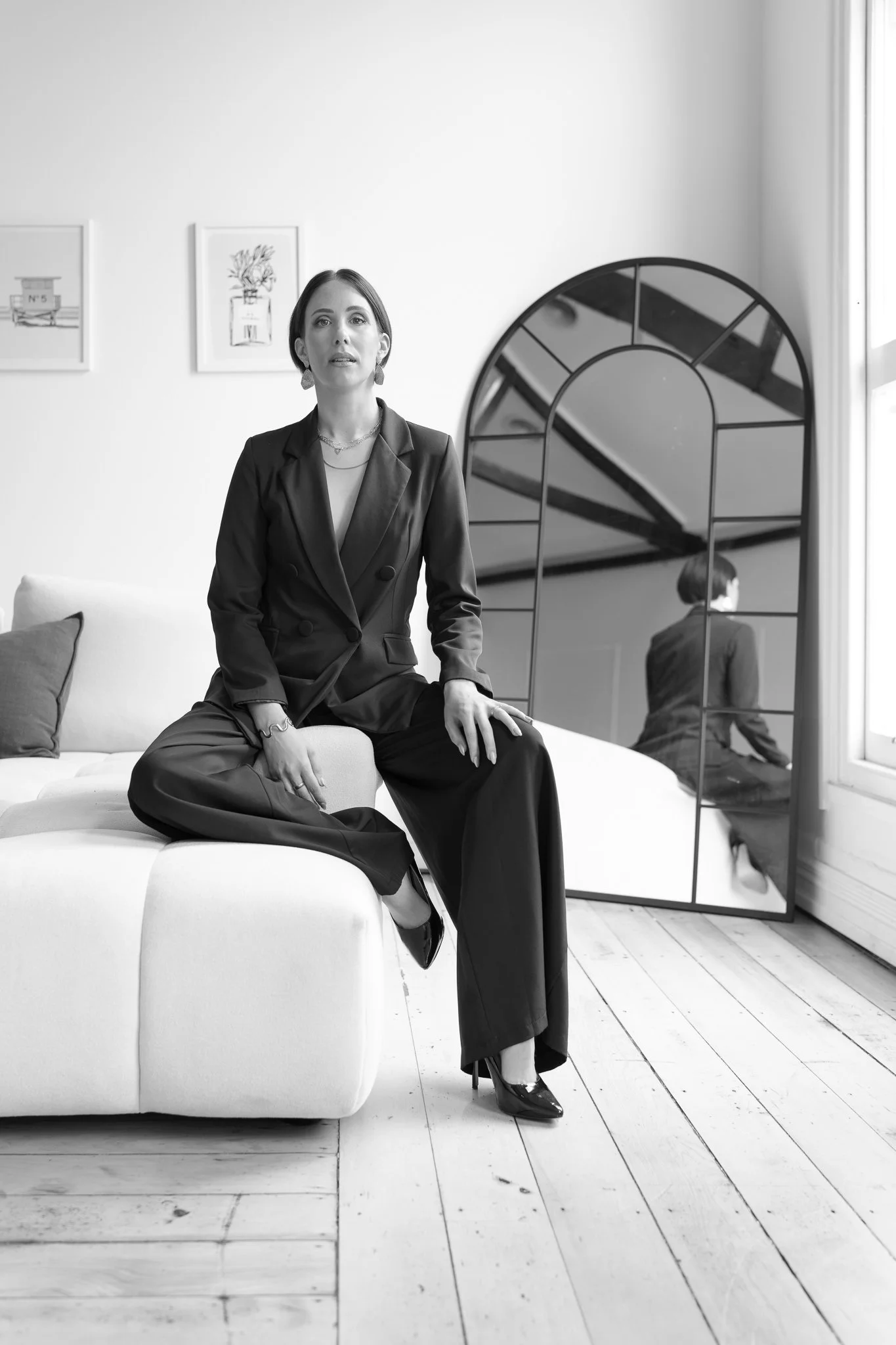 Black and white photo of Nat on a white sofa
