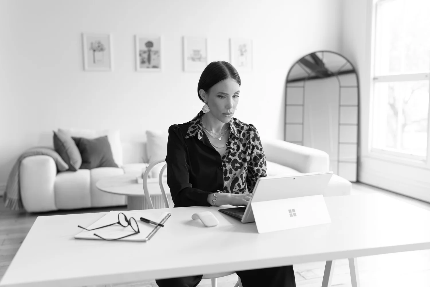Black and white photo of Nat typing on her laptop