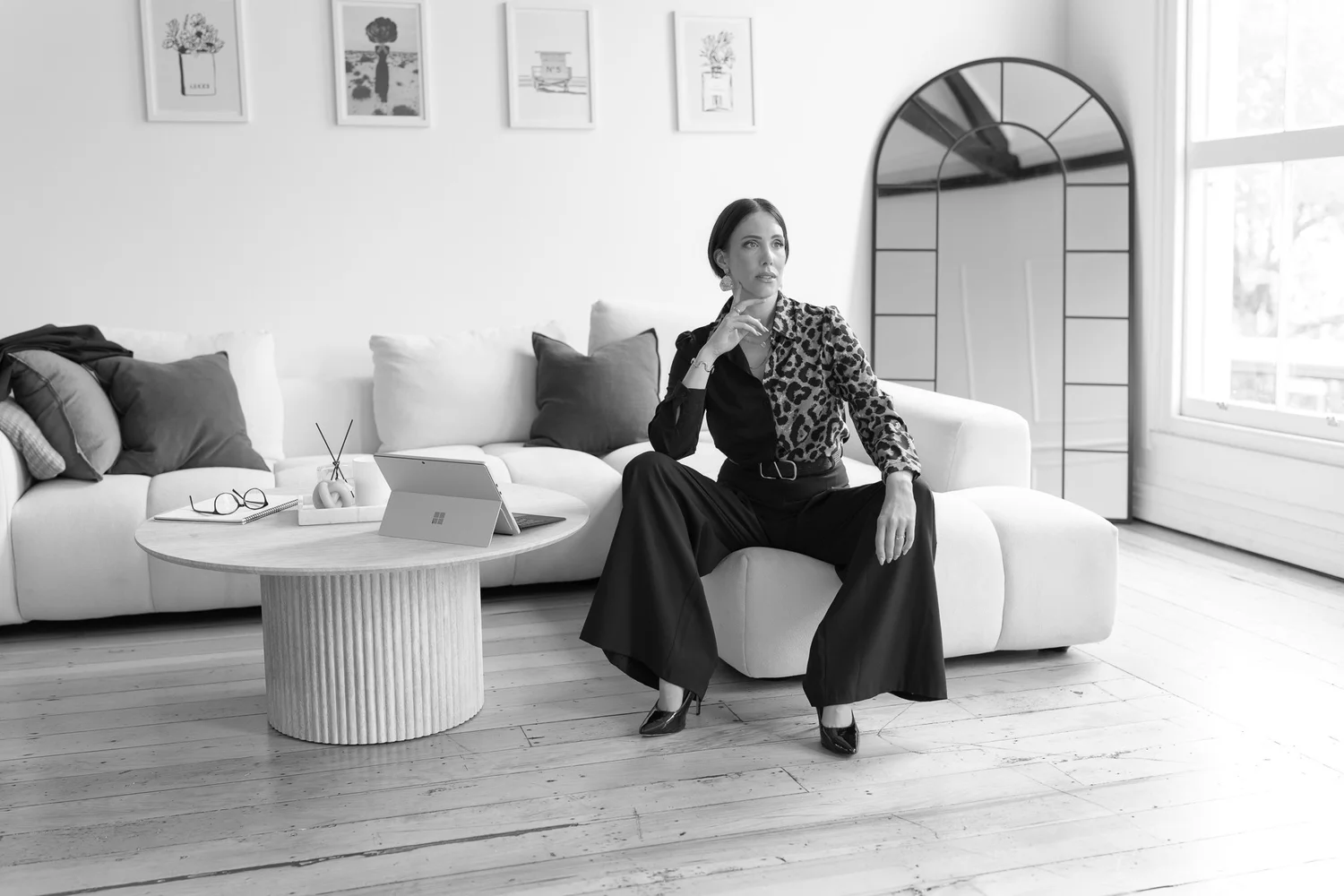 Black and white photo of Nat seated in the lounge