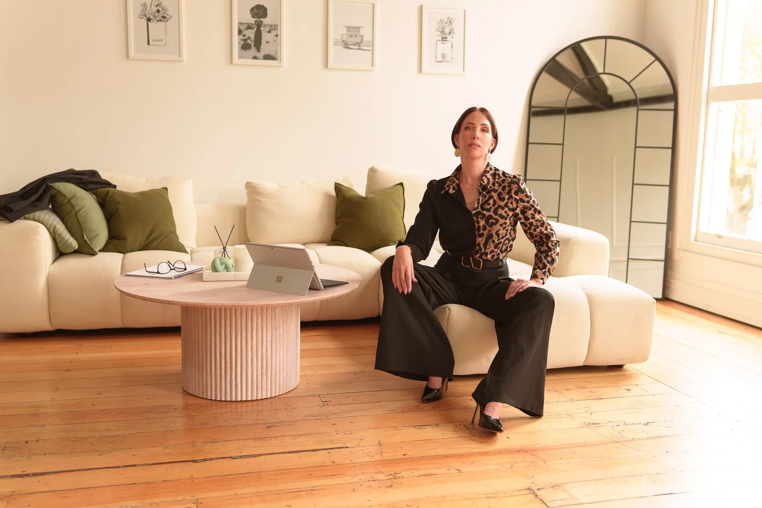 Nat seated on a white sofa beside a fluted coffee table
