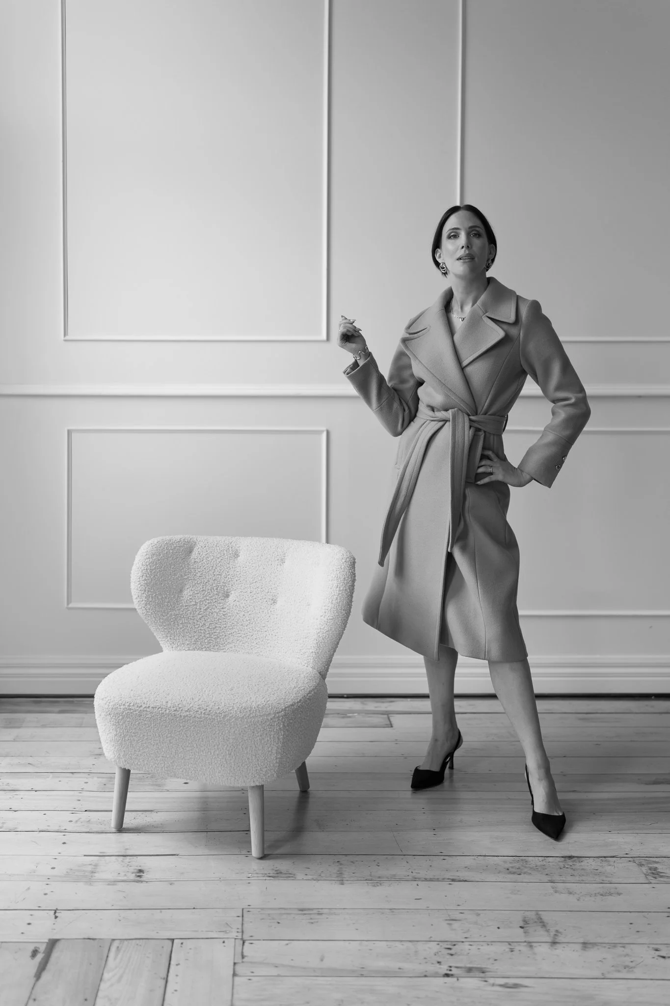 Black and white photo of Nat in a wrap coat
