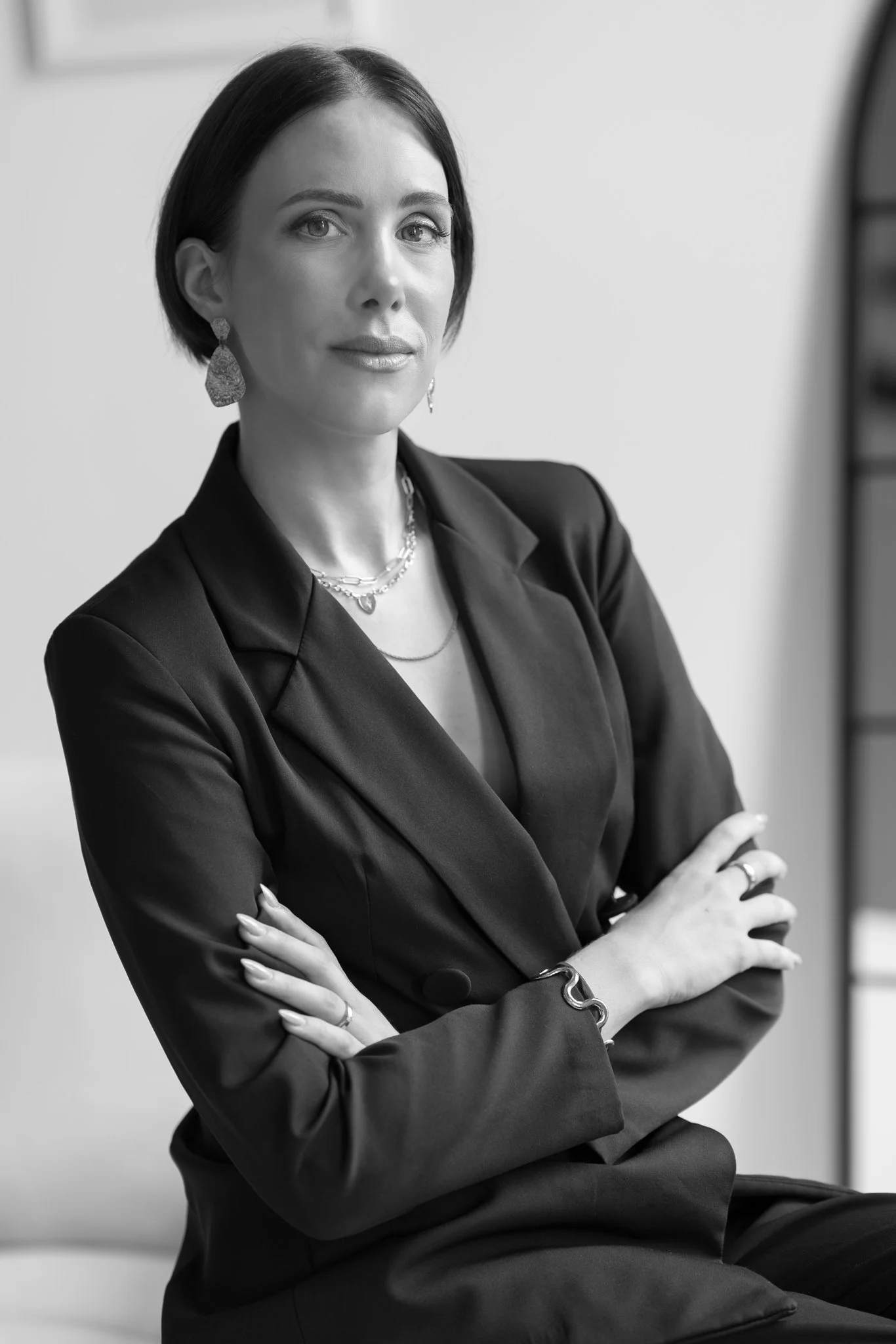 Black and white business portrait of Nat with arms folded