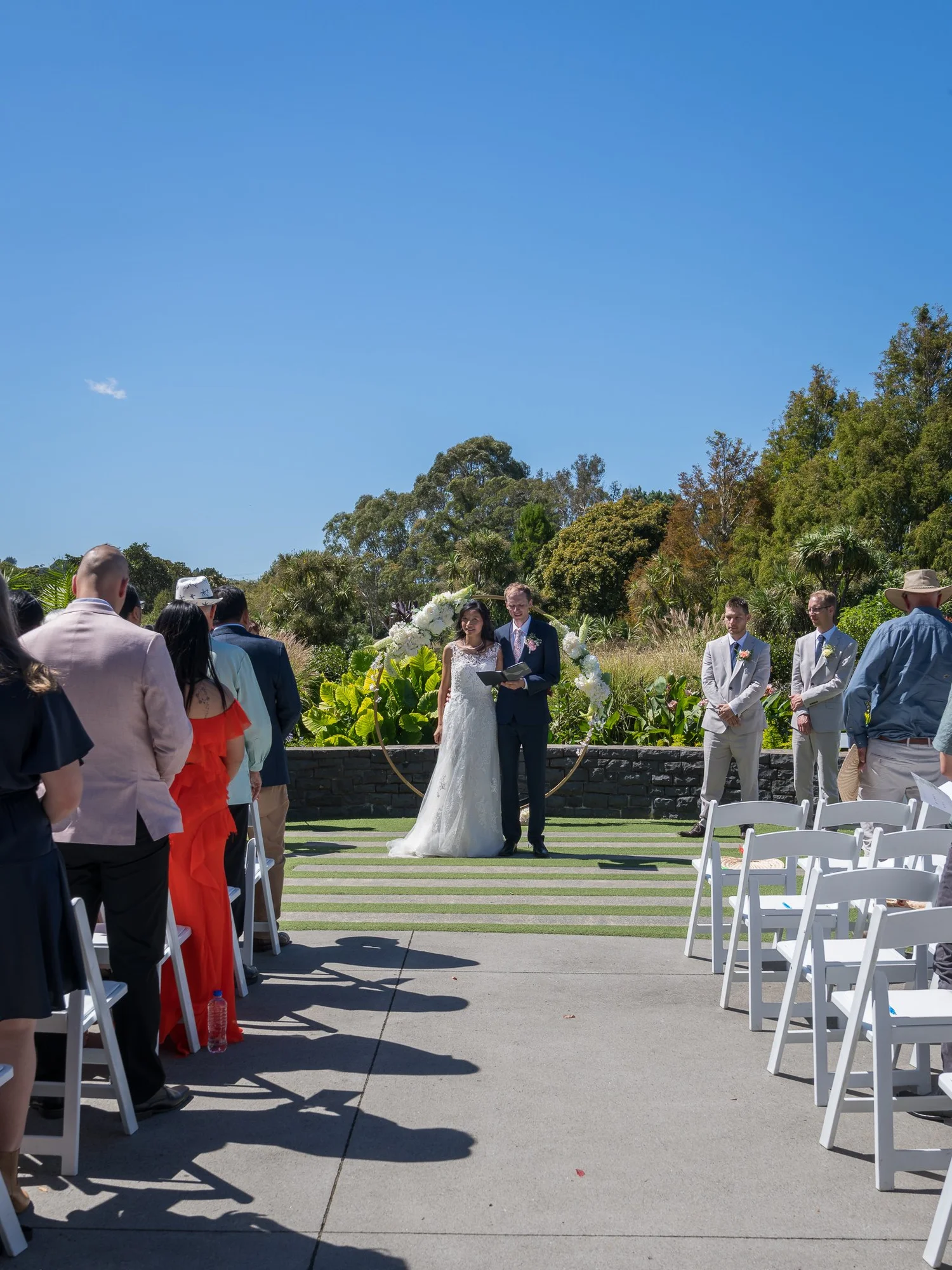 Gel and James stand before their guests at the garden ceremony