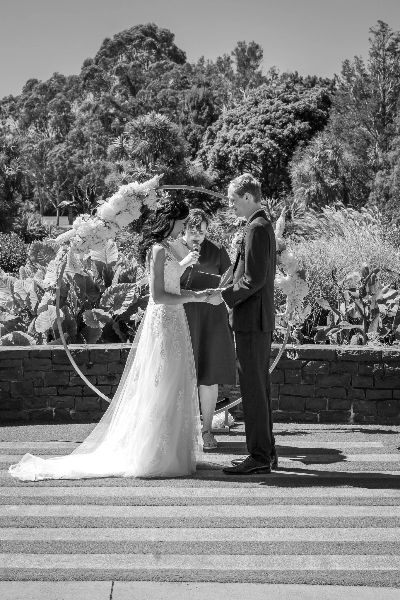 Black and white photo of Gel and James exchanging vows