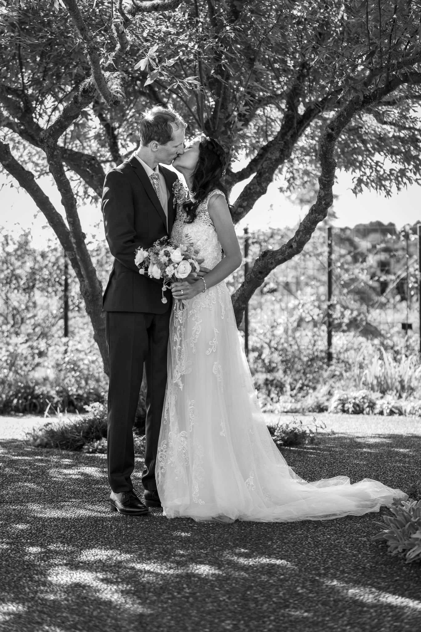 Black and white photo of Gel and James beneath a tree
