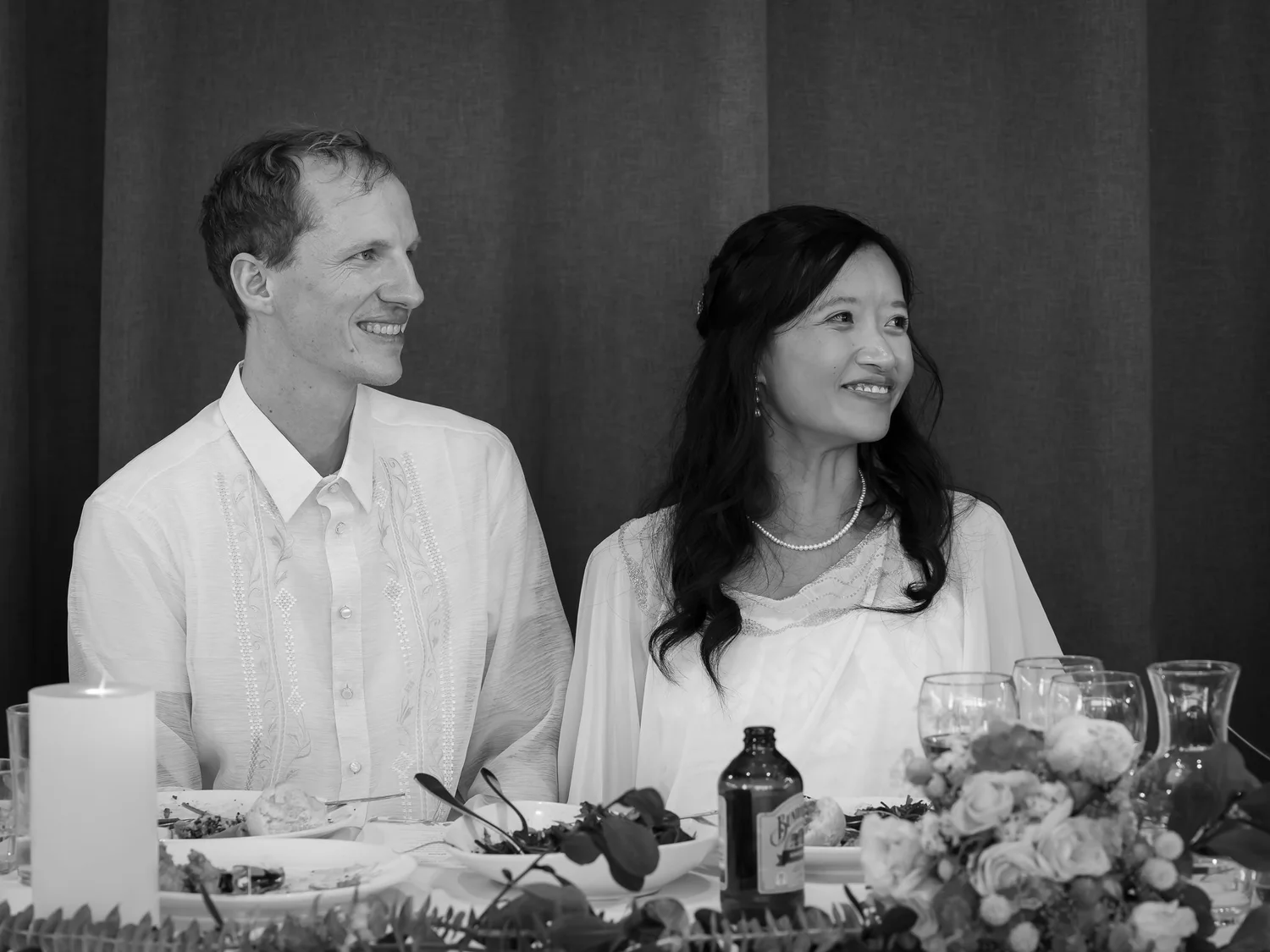 Black and white photo of Gel and James listening to the speeches