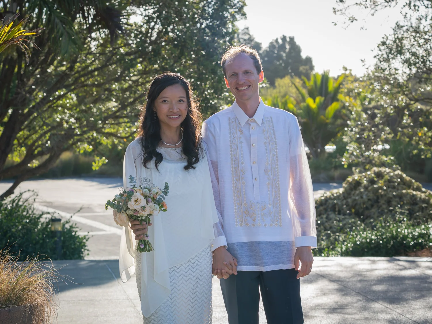 Gel and James in their reception outfits in the garden