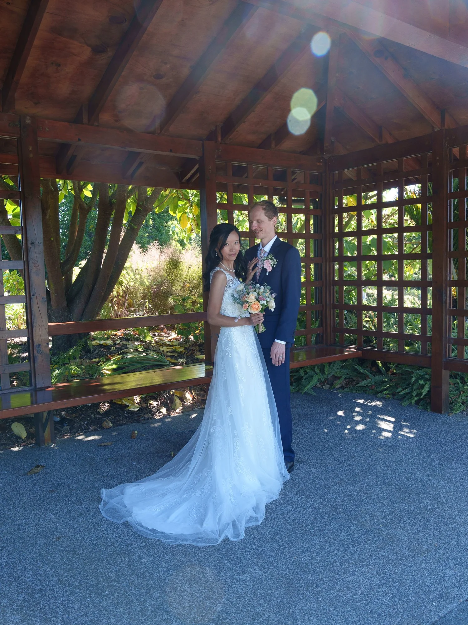 Gel and James embrace inside the garden pavilion