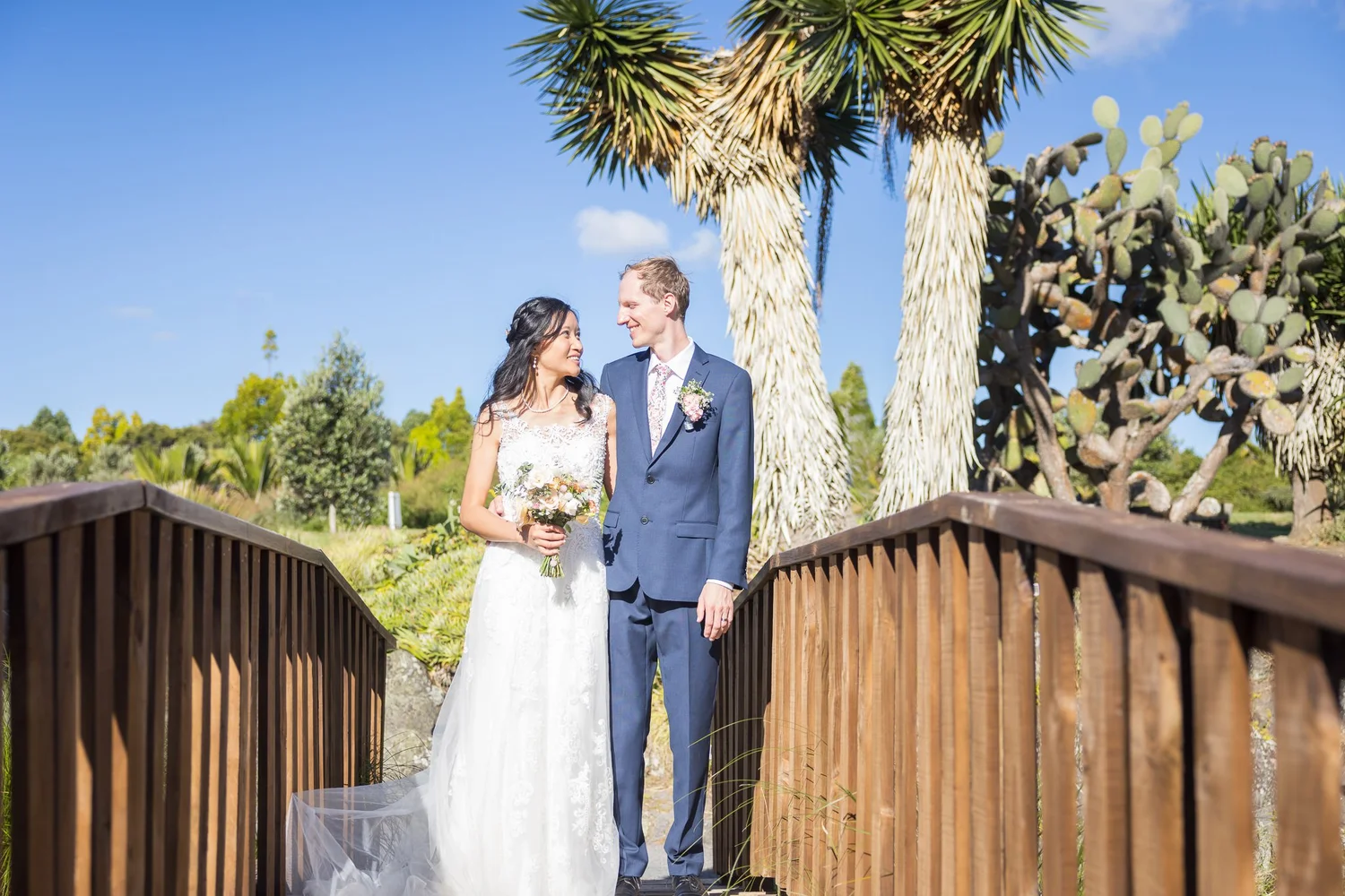 Gel and James on a wooden bridge under blue sky