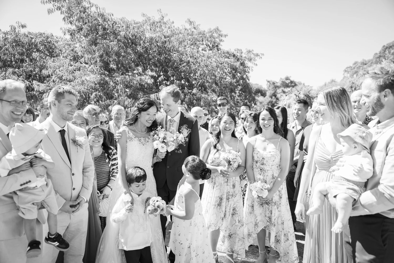 Black and white photo of guests gathered after the ceremony