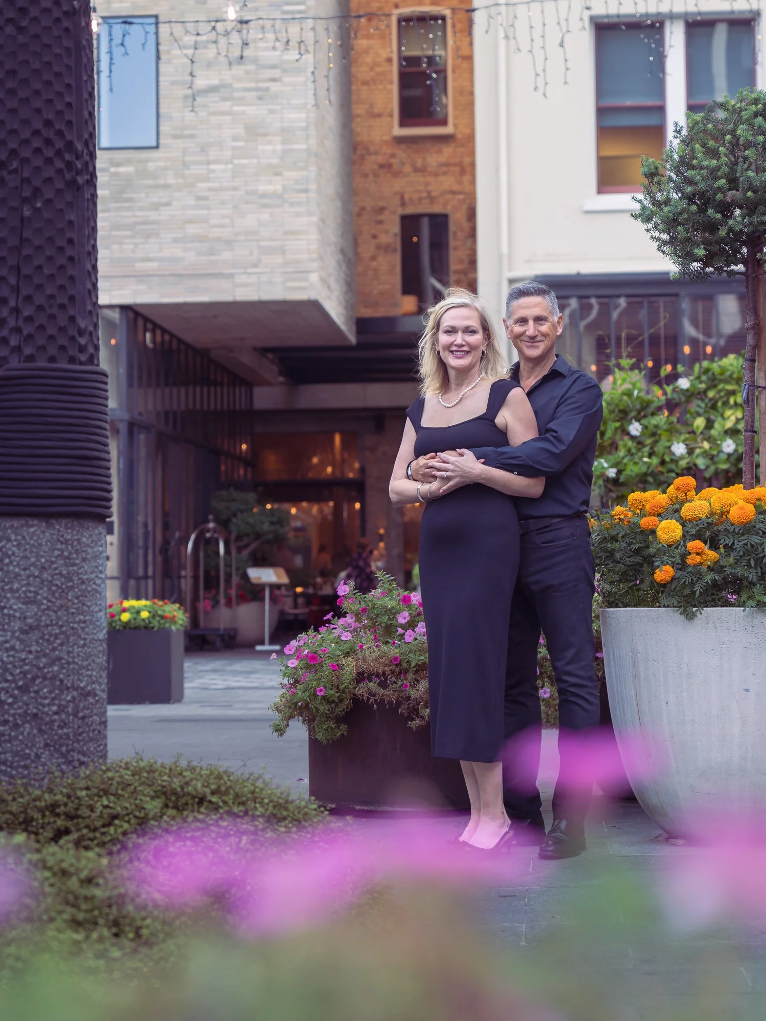 The couple among flowers in a Britomart laneway
