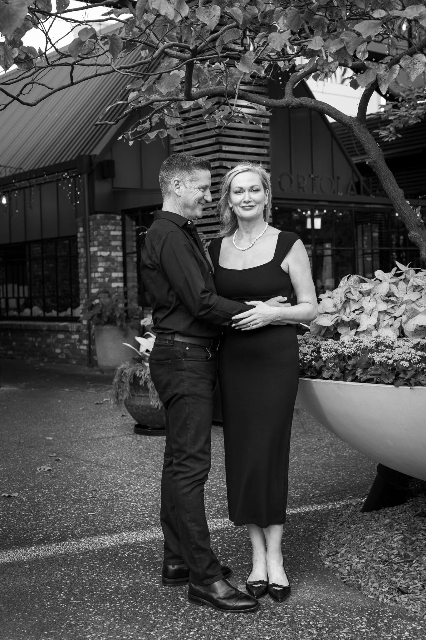 Black and white photo of the couple beside the planters