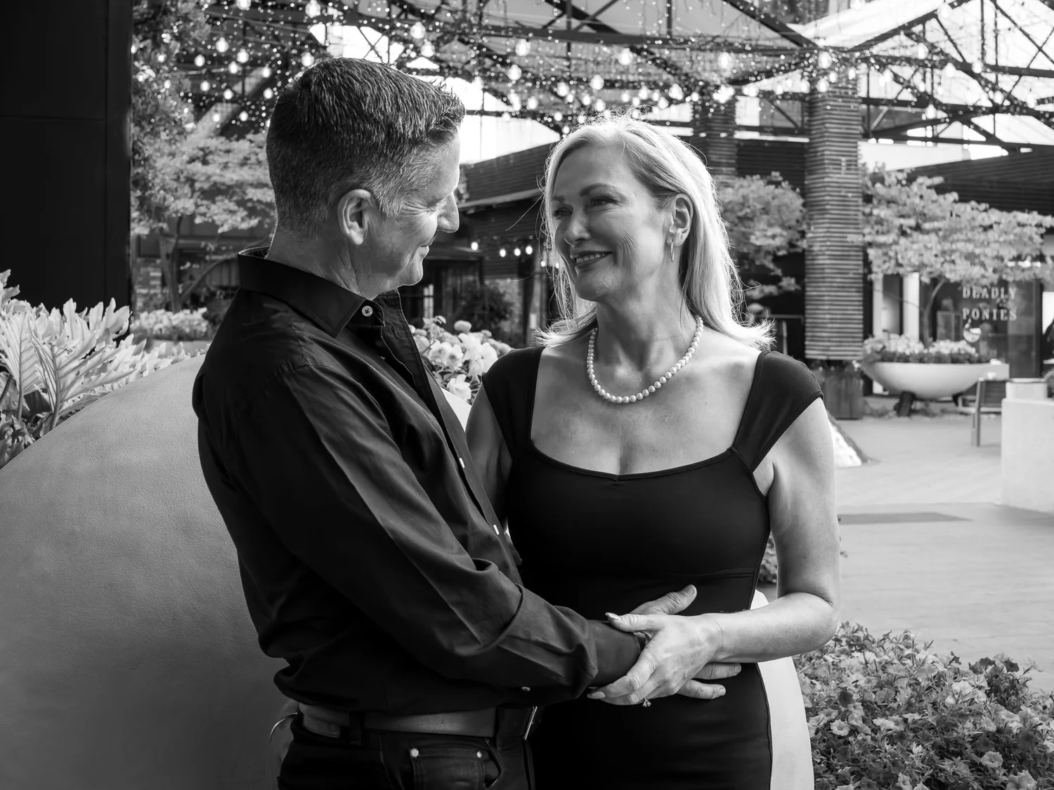 Black and white photo of the couple holding each other close