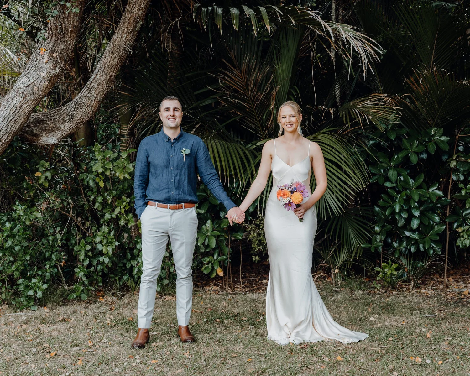 Rebecca and Michael smile hand in hand in the garden