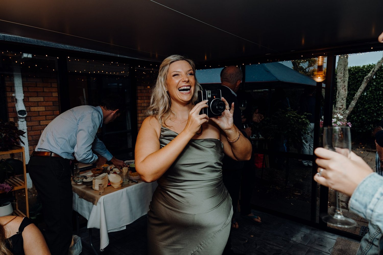 A guest takes a photo at the reception