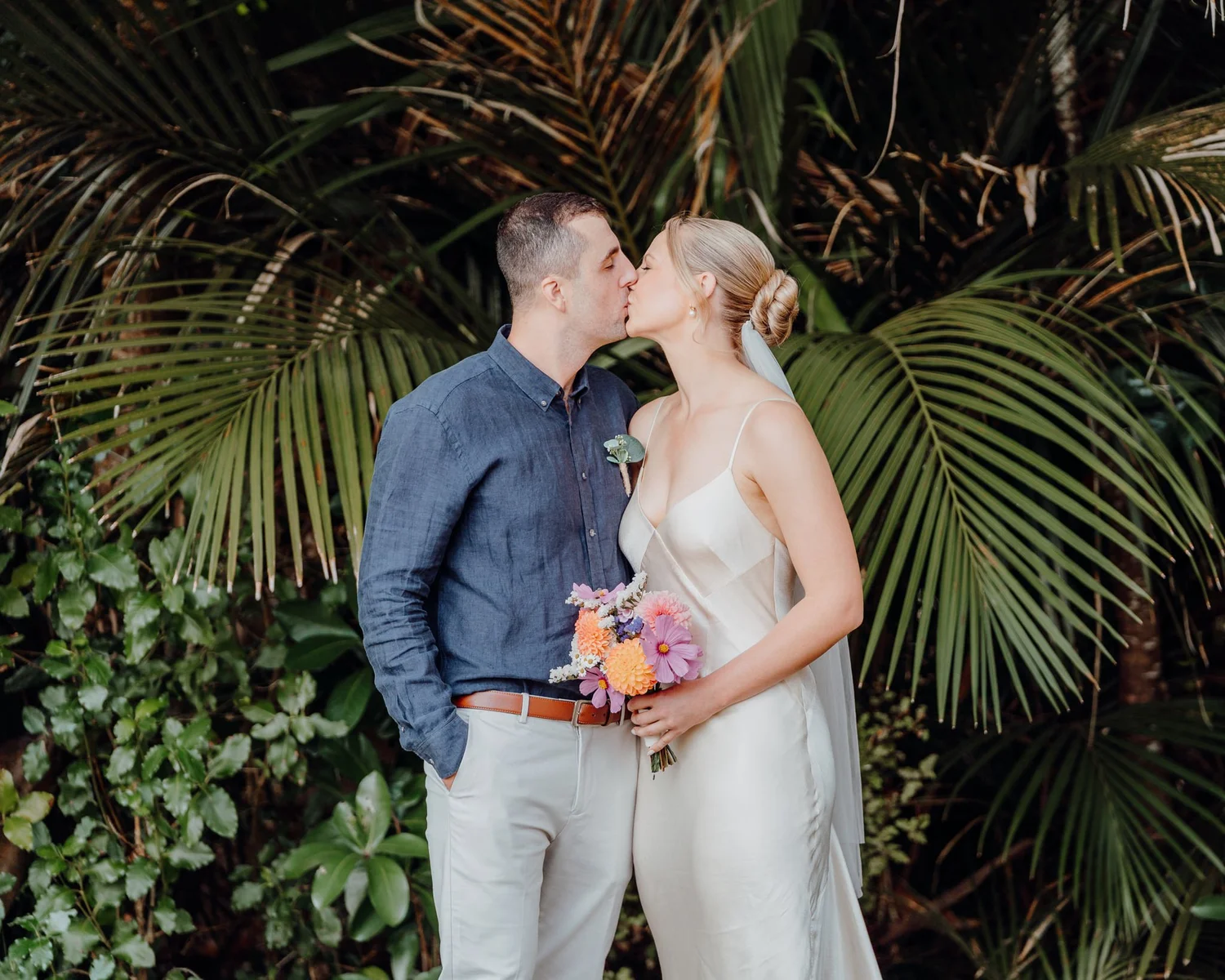 Rebecca and Michael kiss among the nikau palms