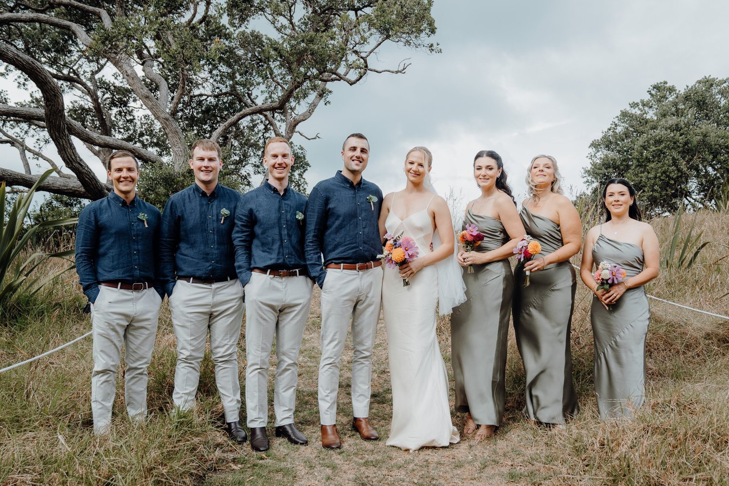 Rebecca and Michael with their bridal party in a paddock