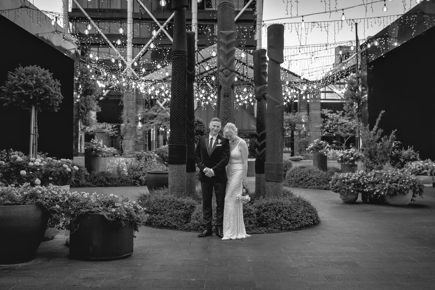 Black and white photo of the couple in the Britomart courtyard