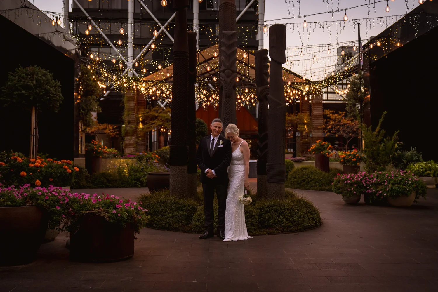 Shannon and Darren among the planters in the Britomart courtyard at dusk
