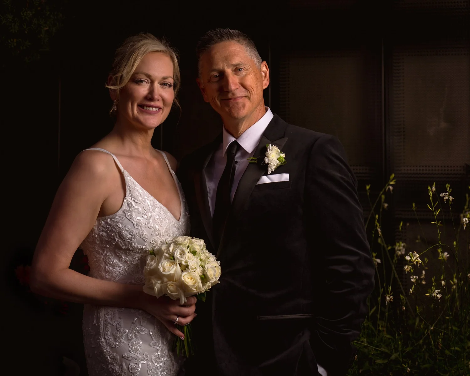 Shannon holds her white bouquet beside Darren