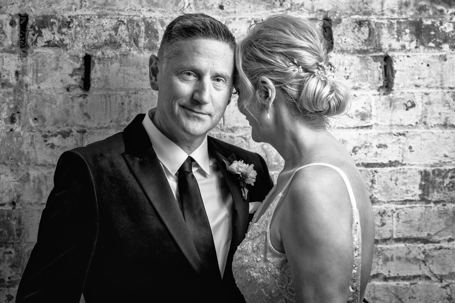 Black and white photo of the couple leaning together