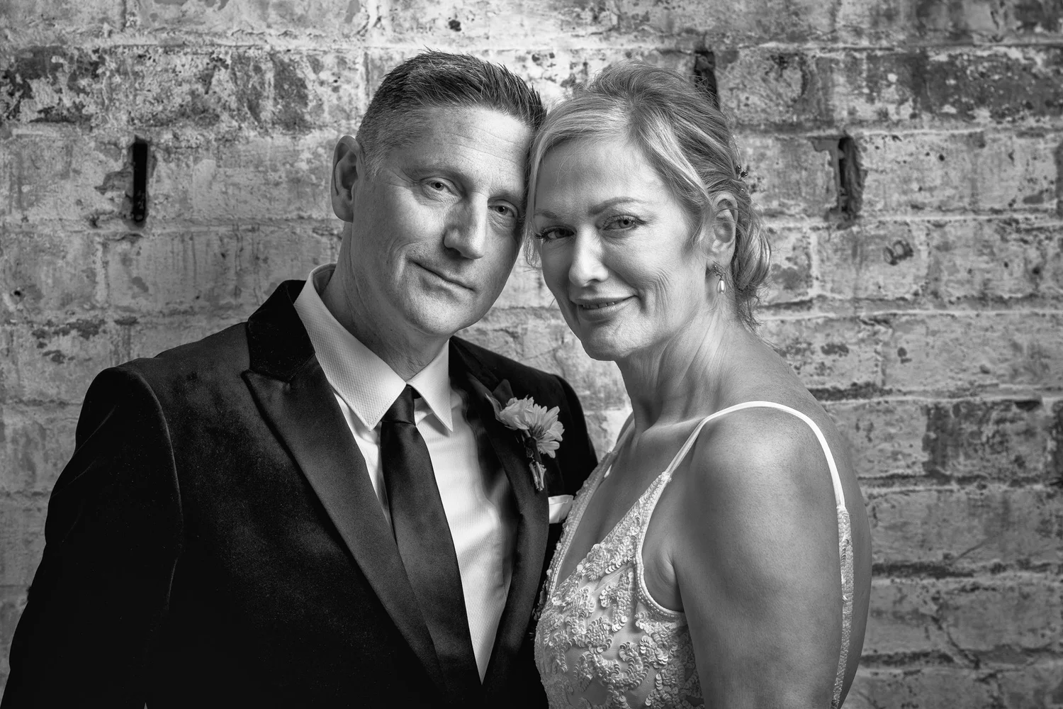 Black and white photo of the couple cheek to cheek