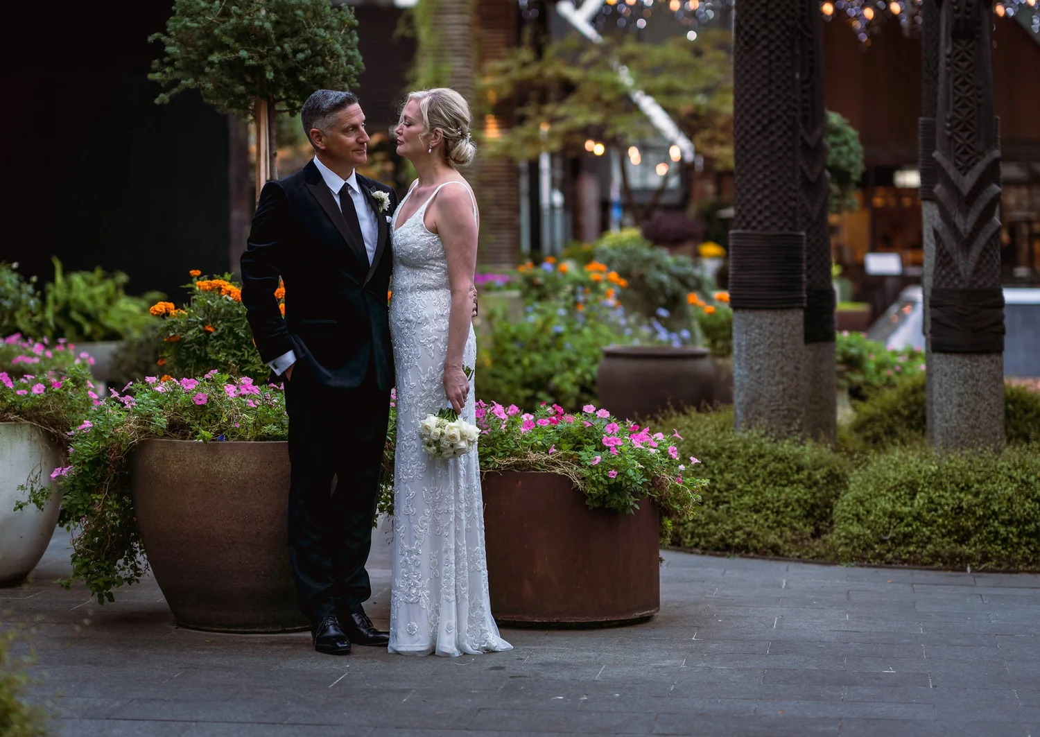 Shannon and Darren among potted plants in the courtyard