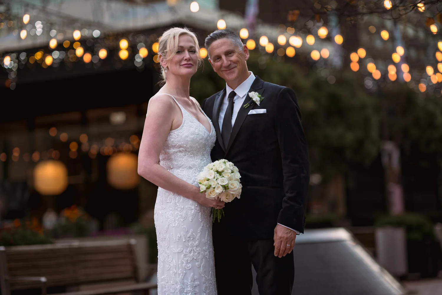 Shannon and Darren under festoon lights at The Hotel Britomart