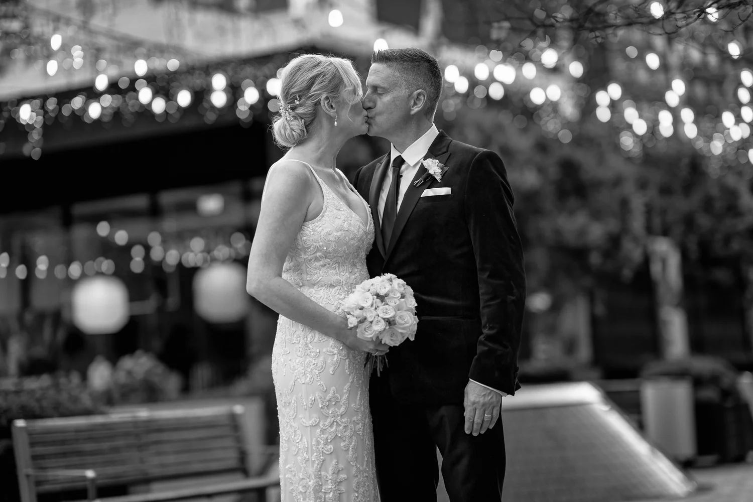 Black and white photo of Darren kissing Shannon's cheek