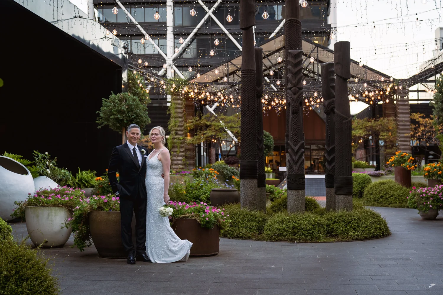 Shannon and Darren stand in the courtyard beneath carved pillars