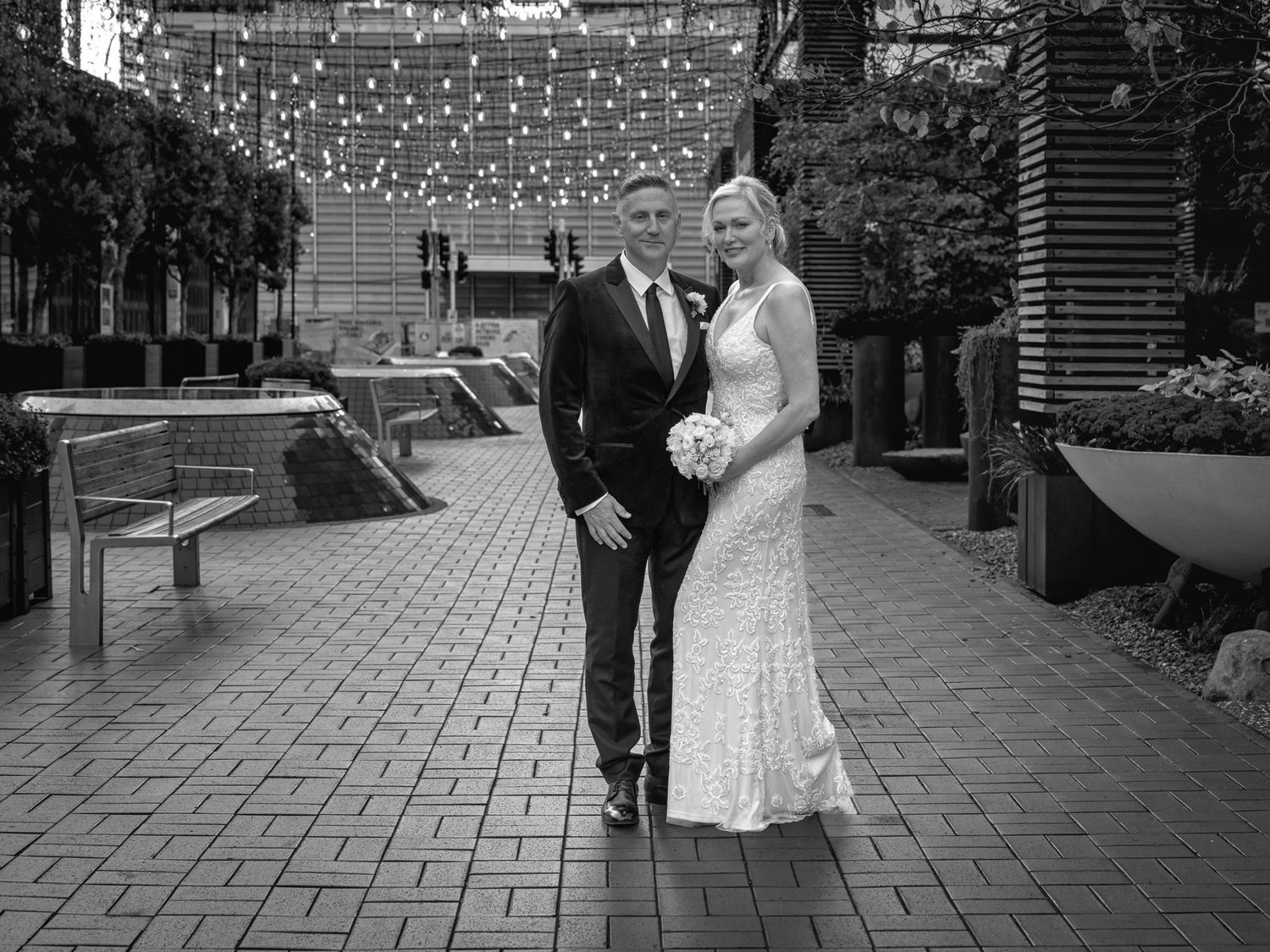 Black and white photo of the couple on the brick plaza