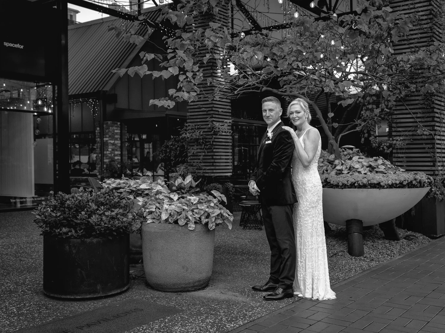 Black and white photo of the couple beneath the trees