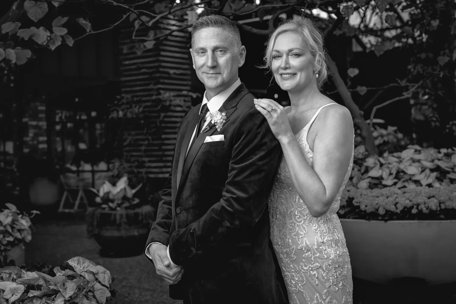 Black and white photo of the couple among the planters