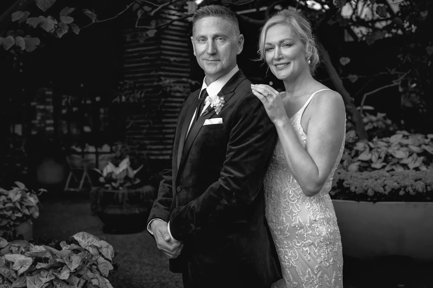 Black and white photo of the couple among the greenery