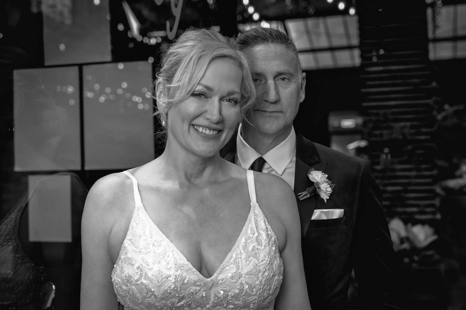 Black and white photo of Shannon smiling in front of Darren