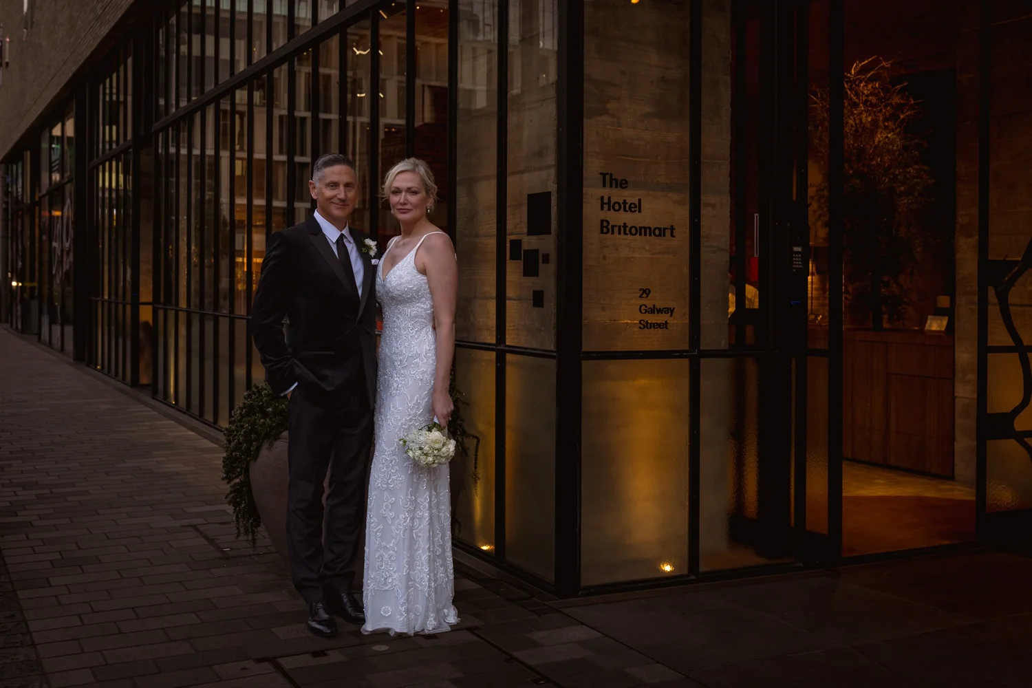 Shannon and Darren outside the hotel's glass frontage