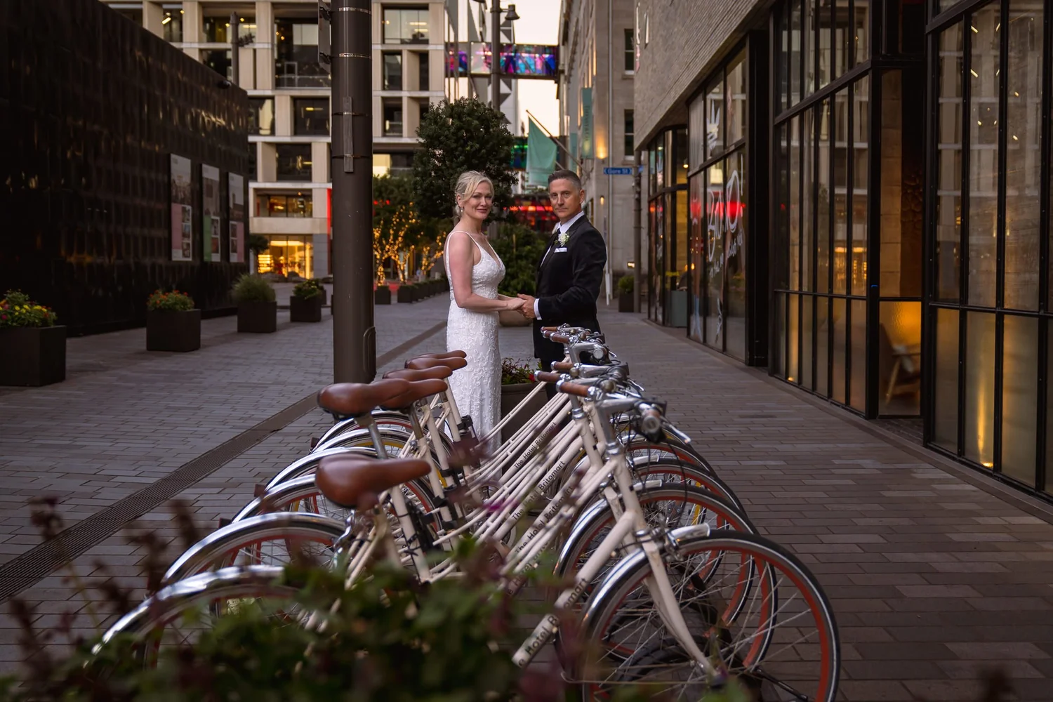Shannon and Darren beside a row of bicycles on a Britomart lane