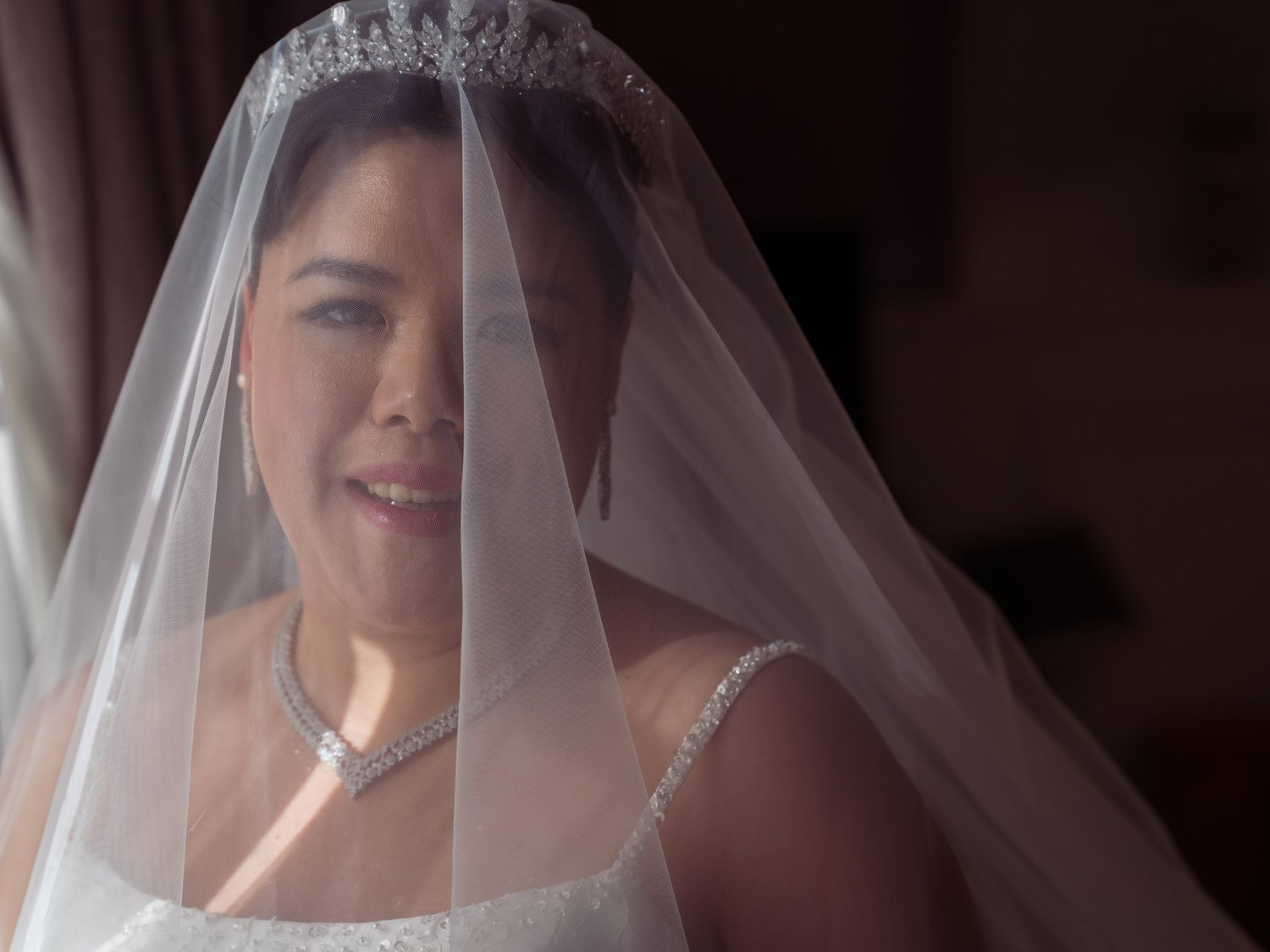 Stephanie smiles beneath her veil