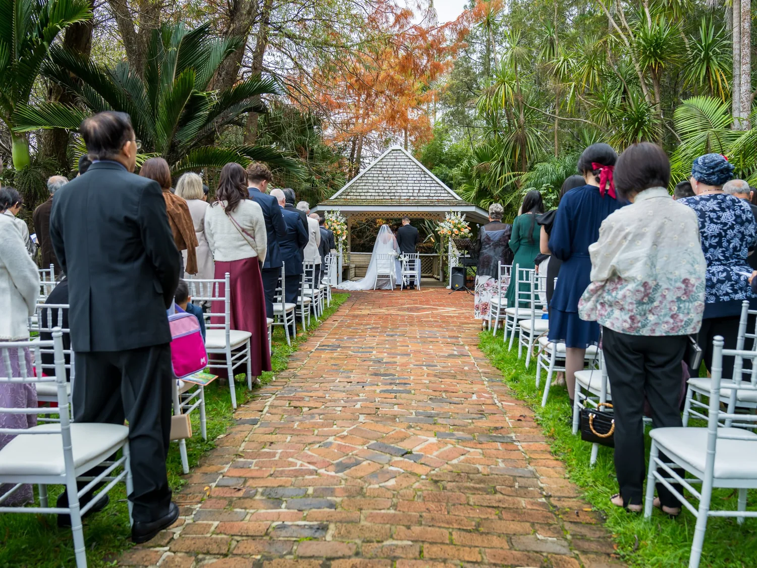 Guests line the brick aisle in the garden