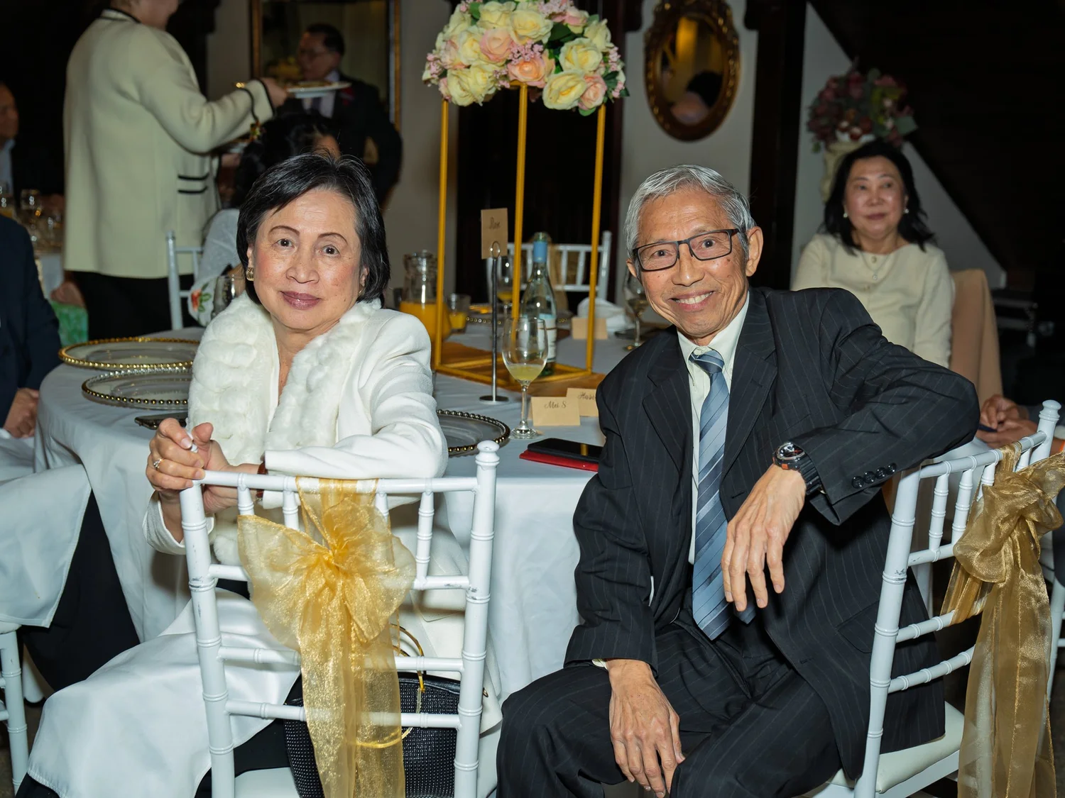 Two guests smile at their table